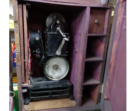 A Vintage cine projector in cabinet.