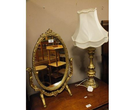 A GILT FRAMED SWING MIRROR AND A GILT TABLE LAMP (2)