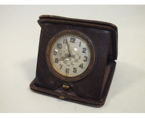 A VINTAGE LEATHER CASED 8 DAY TRAVEL CLOCK 