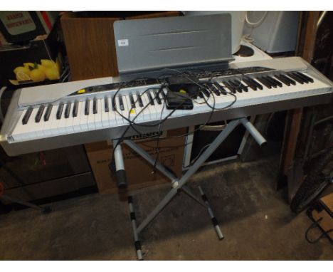 A CASIO KEYBOARD AND STAND