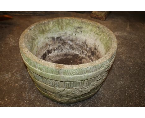 A STONE GARDEN PLANTER WITH BARREL AND IVY LEAF EFFECT