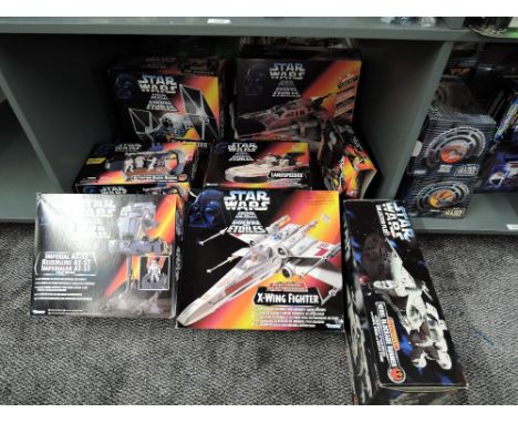 A shelf of modern Kenner Star Wars accessories, Imperial AT-ST, X-Wing Fighter, Detention Block Rescue, Tie Fighter, Imperial