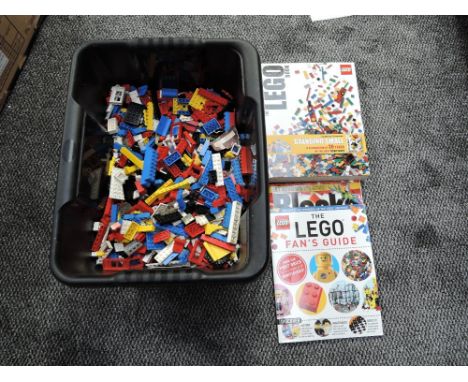A box of vintage Lego pieces along with The Lego Book including Standing Small and The Lego Fans Guide