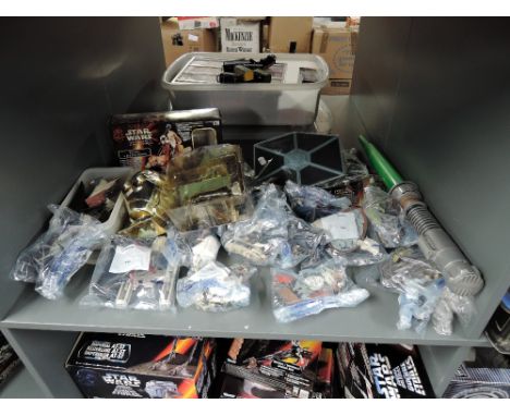 A shelf of modern Kenner and Hasbro Star Wars figures and accessories