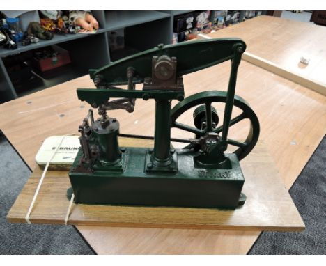 A Stuart Turner Live Steam Beam Engine having spoked flywheel, numbered 80063, on wooden base, length of metal base 33cm, len