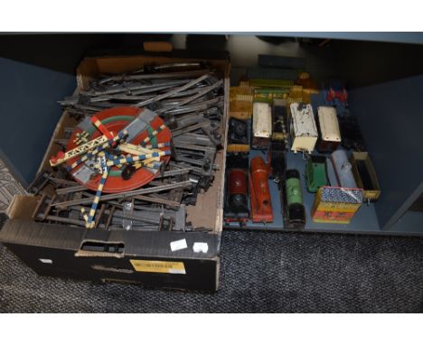 A shelf of Hornby and similar clockwork 0 gauge 0-4-0 loco's and tenders, tin plate rolling stock and accessories along with 