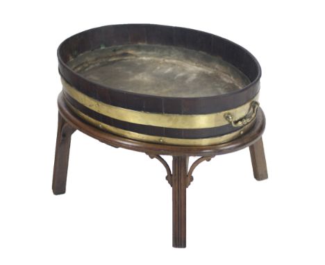 A large oval George III period brass bound mahogany Wine Cooler, with brass carrying handles, approx. 71cms x (28") wide, on 