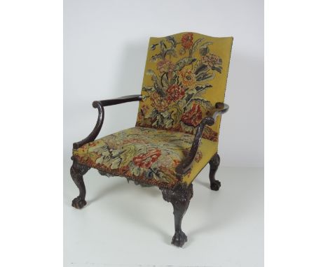 A large early 19th Century Gainsborough Armchair, in the Chippendale style, the upholstered back and seat covered in floral t