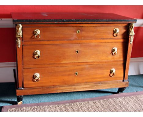 A good early 19th Century French Empire period Commode, or Chest, of three long drawers with brass lion masks drop ring handl