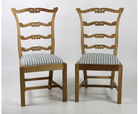 A good set of twelve mahogany ladder back Dining Chairs, each back with four pierced and carved rails, over drop in seats cov