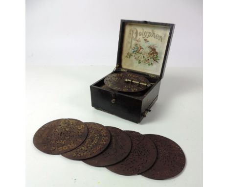 A small late 19th Century Table Polyphon, in original painted box, with 12 circular discs. (1)