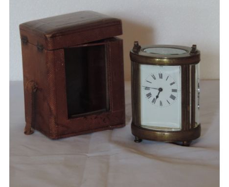 A late 19th Century French brass Carriage Clock, of oval shape, in original carrying case, 12cms (5") high. (1)