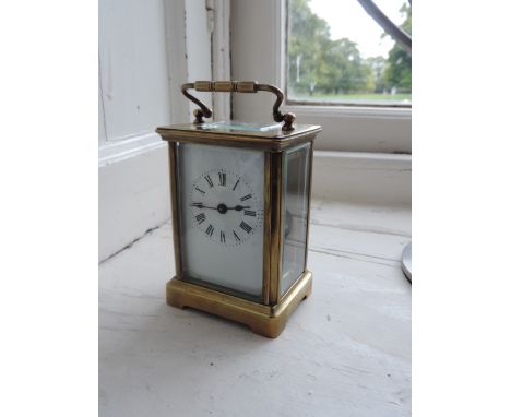 A small early 20th Century brass Carriage Clock, the enamel dial with Roman numerals. (1)