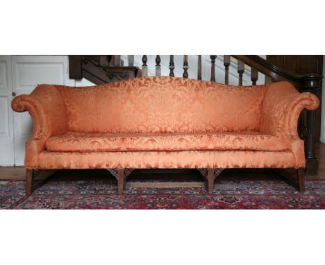 A large 18th Century mahogany framed humped back Sofa, with out scrolled arms, on square tapering legs united by stretchers, 