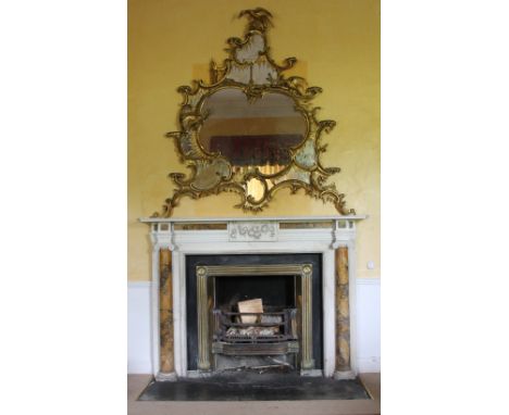 A magnificent 18th Century carved giltwood Overmantel Mirror, in the Chippendale taste, composed of leafy scrolls, shell work