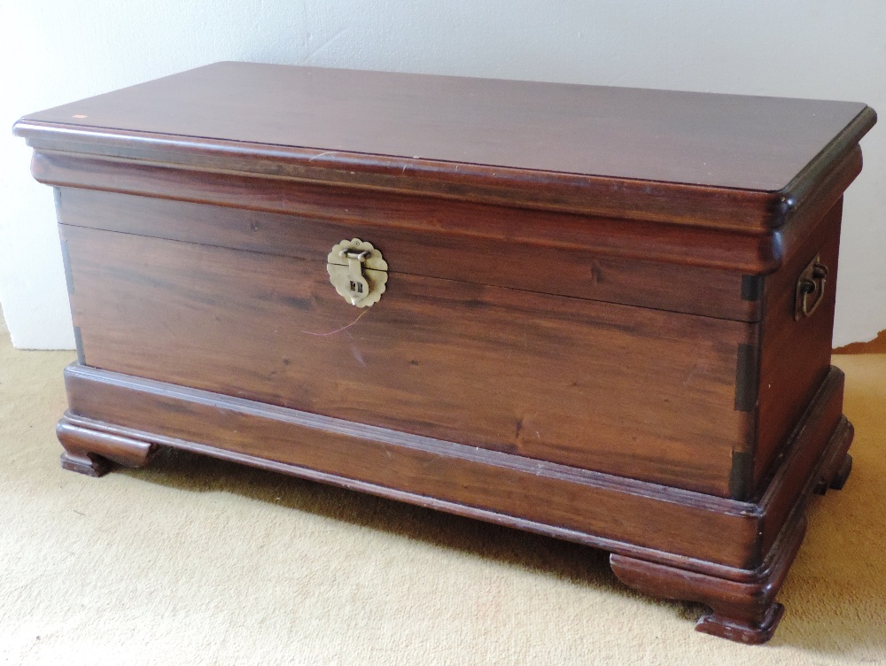 A rectangular mahogany Blanket Chest or Coffer with brass carrying handles, on ogee bracket feet,