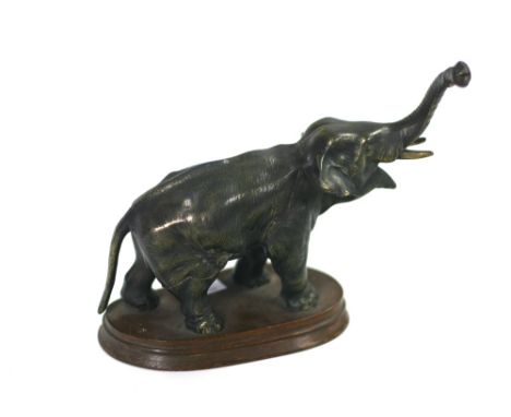 A good metal model of an Elephant, with trunk raised on wooden base. (1)