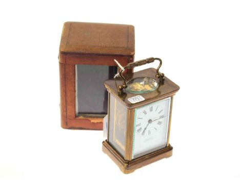 Brass cased carriage clock, retailed by Harrods, in a travel case