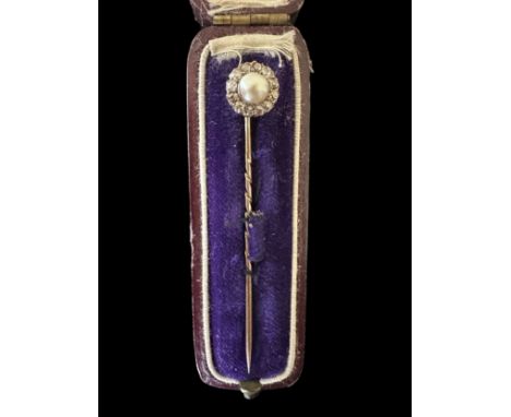 A cased diamond and pearl unmarked yellow metal pin. 63mm in length. Weight 2.17g.Please see the buyer's terms and conditions