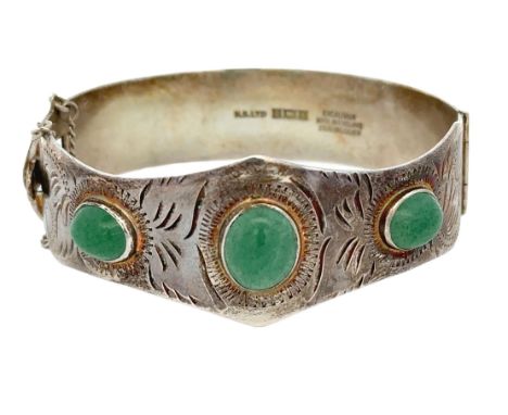 A silver hinged bangle set with three aventurine quartzes. Birmingham hallmarks. Please see the buyer's terms and conditions 