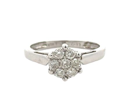 A diamond cluster ring set with seven diamonds, size K. Stamped 18kt and marked as 0.33ct of diamonds. Weight 2.9g. Diamond s