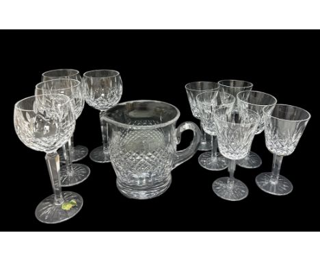 A Waterford Crystal water jug in the Colleen design, height 14.8cm and 10 Lismore design glasses. There are 4 oversized wine 