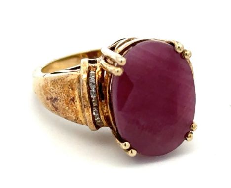 A large ruby and silver gilt ring with white stone shoulders.  stamped 925. Size O. Ruby is treated and approx 16mm x 12mm.  