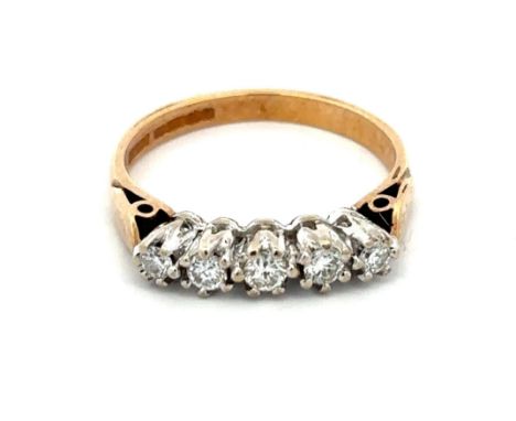 A five stone diamond ring set in 9ct yellow gold with a white gold gallery, size P. Diamond weight approx 0.24ct. Weight 3.26