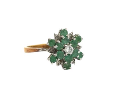 An 18ct gold emerald and diamond flower ring. Size K. Total weight 3.67g. 1977 London hallmarks. Please see the buyer's terms