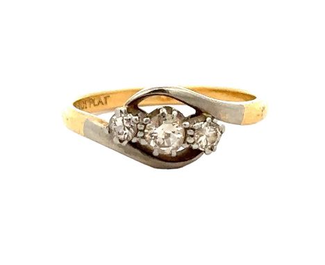 A diamond three stone crossover ring, size K. Weight 2.2g. Stamped '18ct PLAT.' Please see the buyer's terms and conditions f