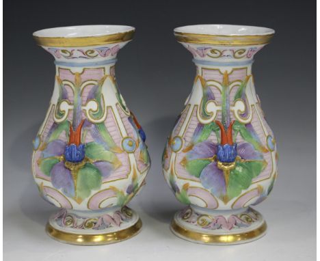 A pair of French bisque porcelain vases, circa 1900, the pear shaped bodies relief moulded with flowers against a textured pi