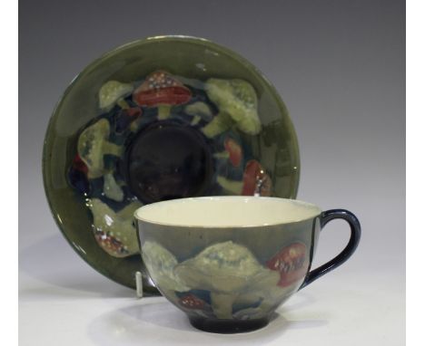 A Moorcroft Claremont pattern cup and saucer, circa 1928-49, impressed marks and painted initials to bases, printed Royal War