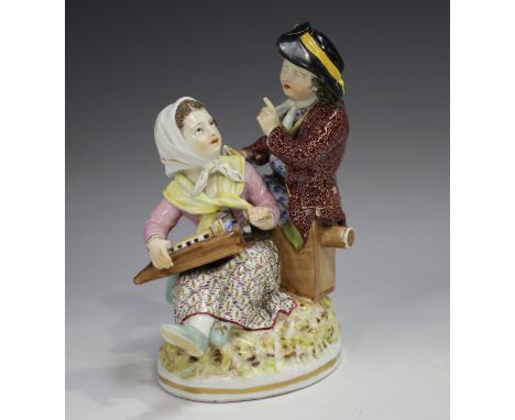 A Berlin porcelain figure group, 19th century, modelled as a seated courting couple, the lady playing a hurdy gurdy, the man 