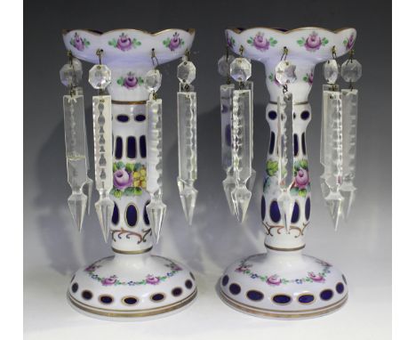 A pair of Bohemian blue glass and white flash overlay table lustres, late 19th century, painted with floral sprays, hung with