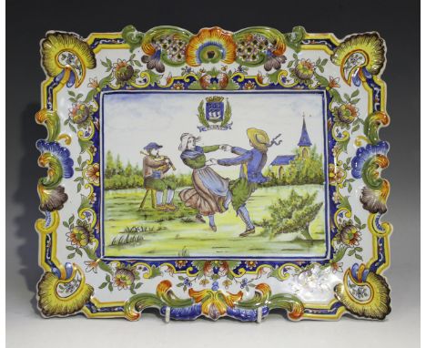 A French faience rectangular wall plaque, early 20th century, possibly Rouen, painted with a dancing couple within a landscap