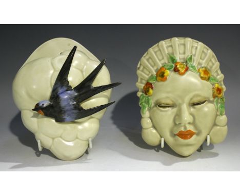 A Clarice Cliff Newport pottery wall pocket, modelled as a swallow amongst clouds, printed mark to reverse, length 19.5cm, an