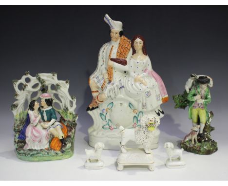 A small group of Staffordshire figures, early 19th century and later, comprising a Highland couple seated beneath an arbour, 