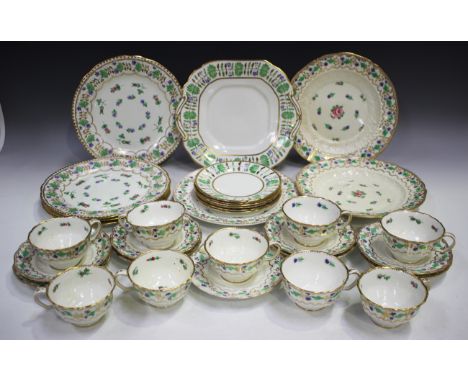 A Staffordshire porcelain part tea service, mid-19th century, painted with a border of cornflowers, comprising nine cups and 