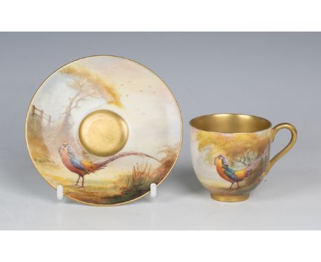 A Royal Worcester gilt lined cabinet cup and saucer, late 1920s, painted by Sedgley, signed, with a golden pheasant amidst tr