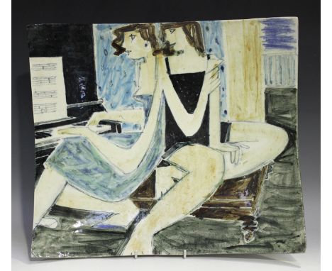 A Derek Davis studio pottery curved rectangular platter, painted with two ladies, one playing a piano, painted signature to b