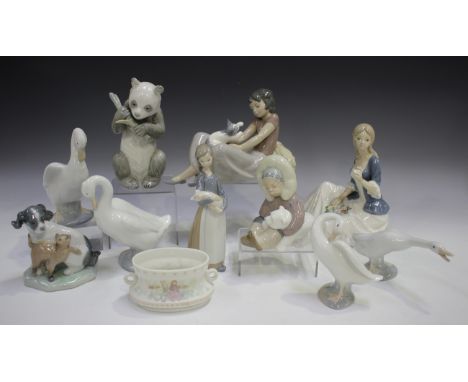 A Lladro porcelain figure Eskimo, No. 1195, a Lladro figure Girl with Pig, No. 1011, two Lladro models of geese and a Lladro 