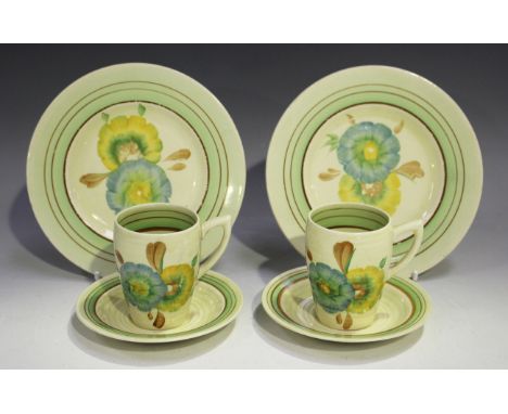 A pair of Clarice Cliff Honeydew pattern trios, 1930s/40s, comprising coffee cup, saucer and side plate, printed marks to bas