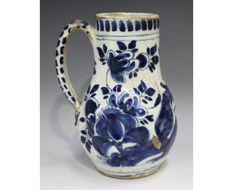 A Dutch Delft jug, late 17th/18th century, the spiralling ribbed body painted in blue with a peacock amongst flowers, height 