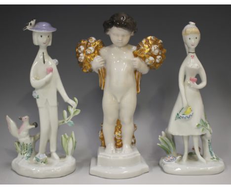Two Rosenthal porcelain figures, designed by Peynet, 20th century, modelled as a standing lady and gentleman, each holding a 