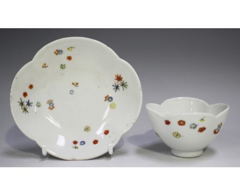 A rare Meissen teabowl and saucer, circa 1730, of quatrelobed shape, enamelled in Kakiemon style with scattered flowerheads a