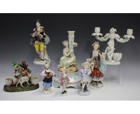 A small group of mainly Continental porcelain figures, mostly 19th century, including a Meissen figure of a gentleman holding