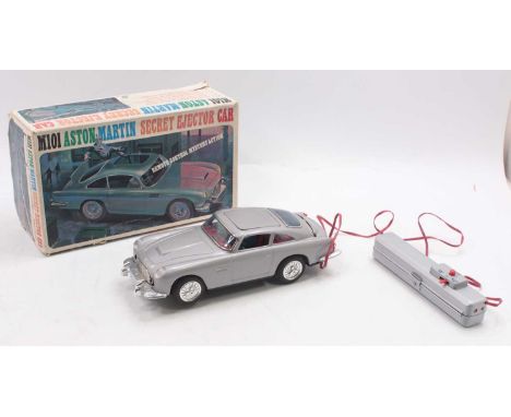 James Bond 007, United M101 Aston Martin Secret Ejector Car battery operated by remote control, silver tinplate body with red