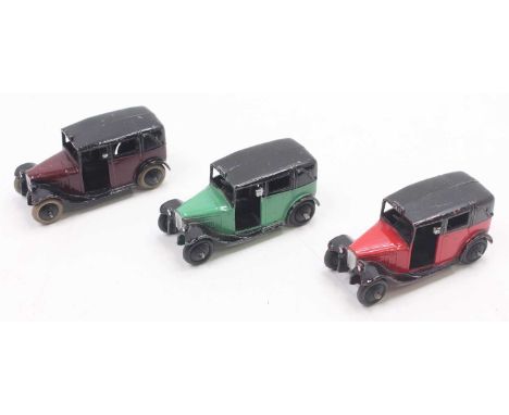 Dinky Toys No.36G Taxi group, 3 examples, to include green/black, red and black, and a Pre War Maroon and black with black sm