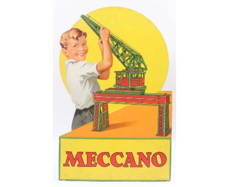 An original Meccano shop display card, depicting a young boy playing with a red &amp; green Meccano model crane, yellow/orang