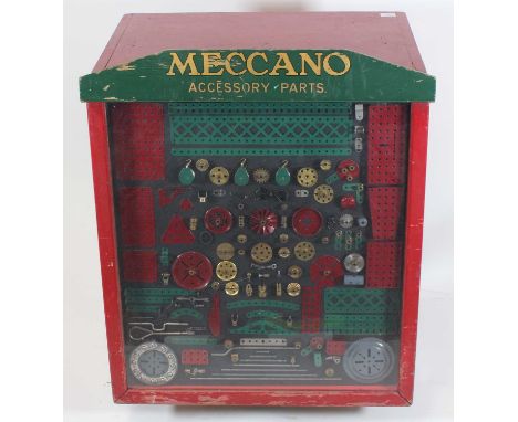 An original Meccano dealer display chest comprising of slope front cabinet with 6 drawers, the glazed front depicting various